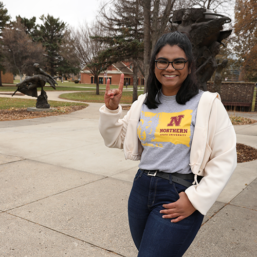 Female student standing outside on patio